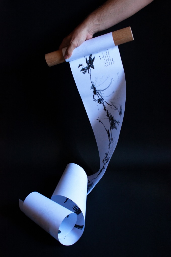 A hand holding a long curled strip of printed paper