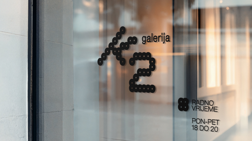 Gallery K2 logo and opening hours displayed on the gallery entrance