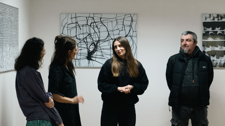 Artists and visitors in conversation during an exhibition at Gallery K2
