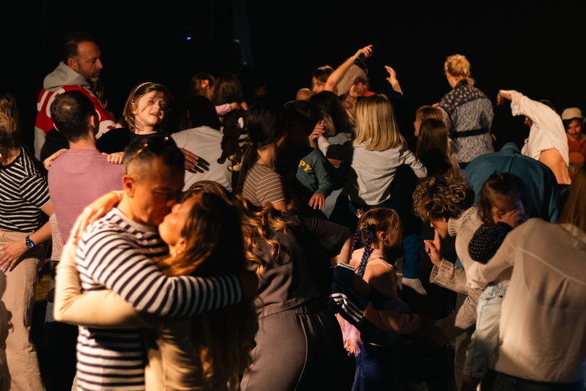 Children and adults gathered together during a festival performance