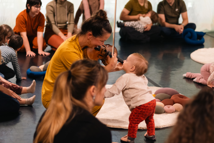 Children and adults taking part in a shared creative workshop