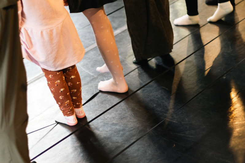 Children and adults moving together during a workshop