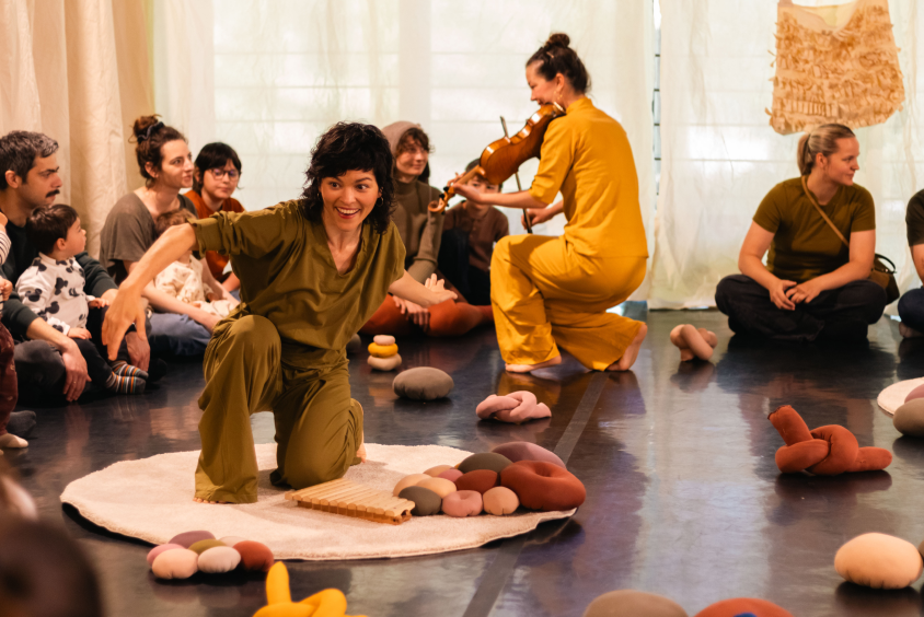 Children and performers participating in an interactive floor performance