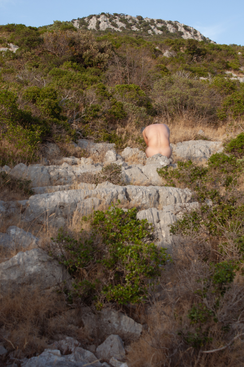 Distant human figure positioned among a rocky natural landscape