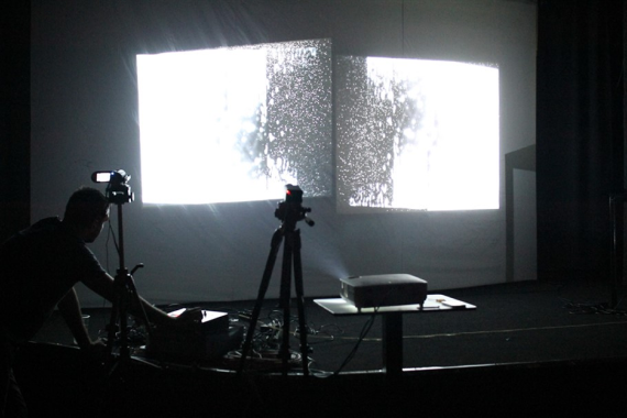 Dark multimedia performance with projected visuals
