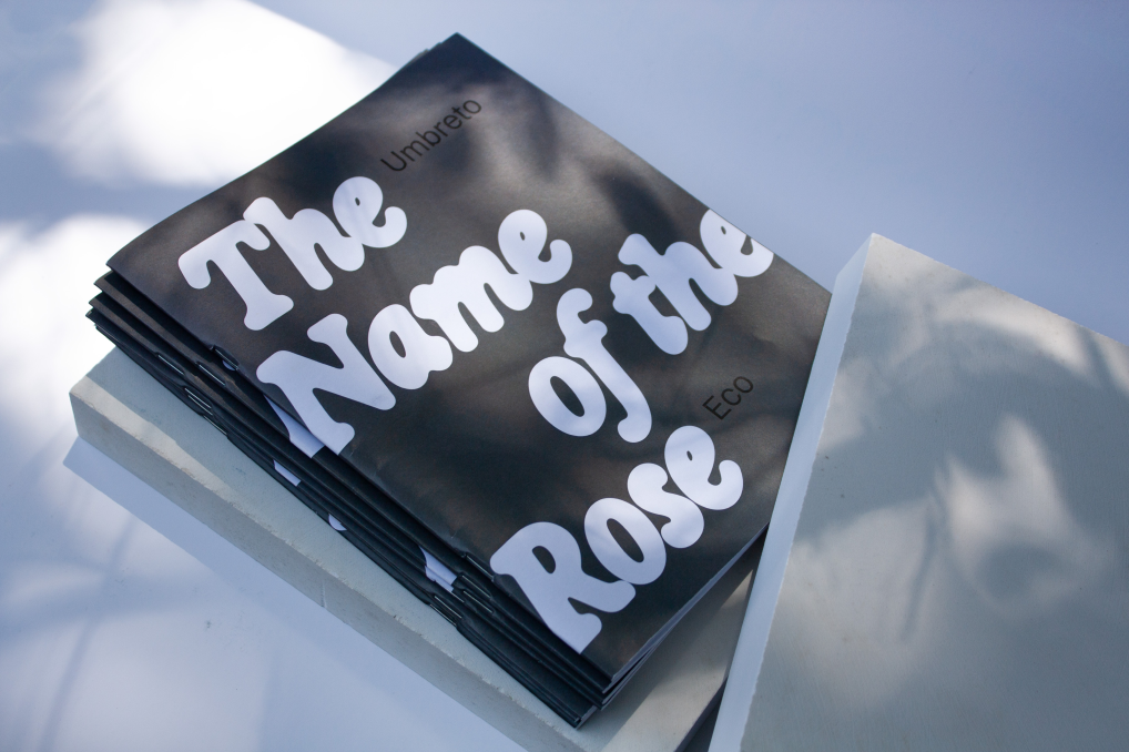 The Name of the Rose book resting on its lower stone block