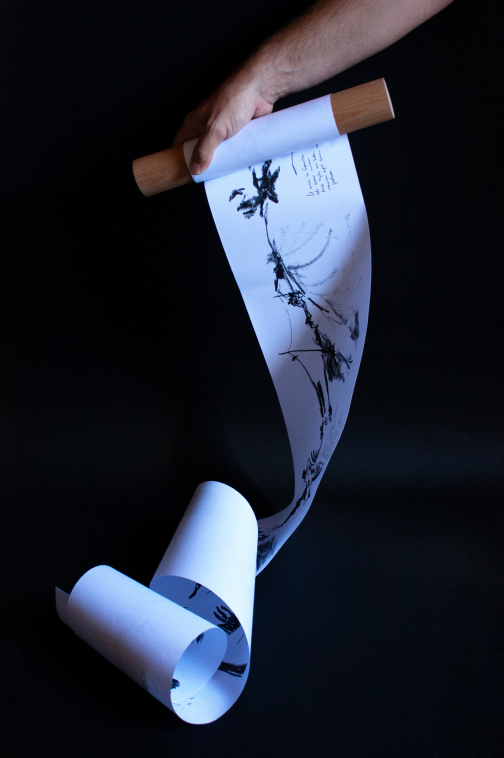 Illustrated scroll hanging open between two wooden rollers