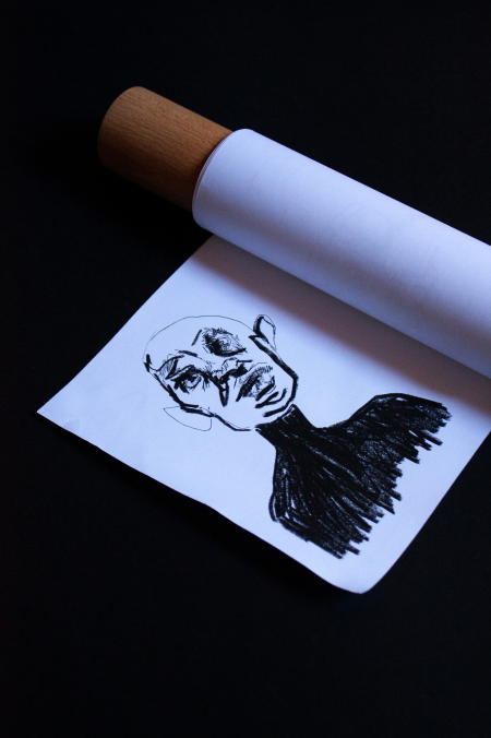 Scroll partially unrolled to reveal the illustrated character portrait