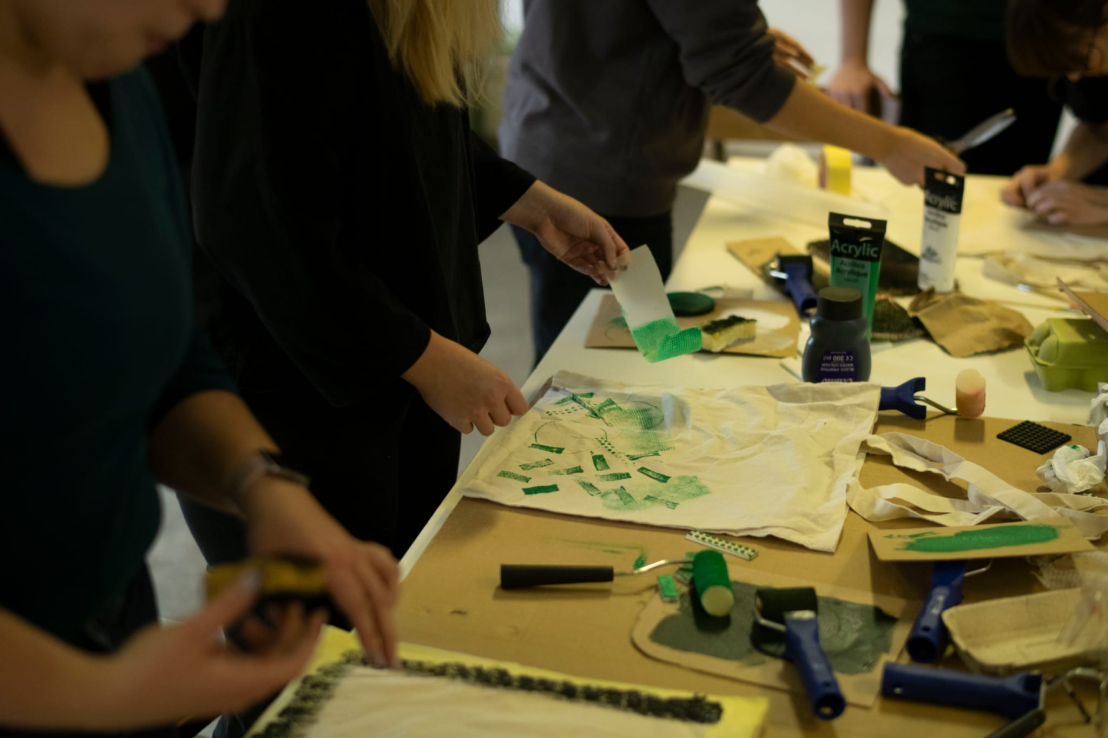 Participants creating green printed designs during a workshop