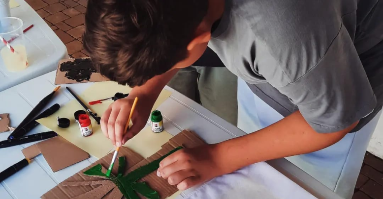 Participant cutting and arranging materials for a printmaking project